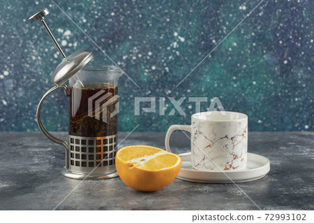 A white ceramic cup of drink with teapot on a marble background 72993102
