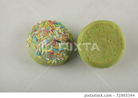 Two green sweet doughnuts on a white background 72993344