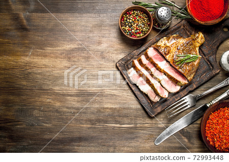 Beef grill with spices on a cutting Board. Beef grill with spices on a cutting Board. 72993448