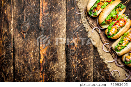 Street food. hot Dogs with herbs, vegetables and hot mustard. Street food. hot Dogs with herbs, vegetables and hot mustard. 72993605
