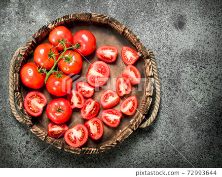 Fresh tomatoes on the tray. 72993644