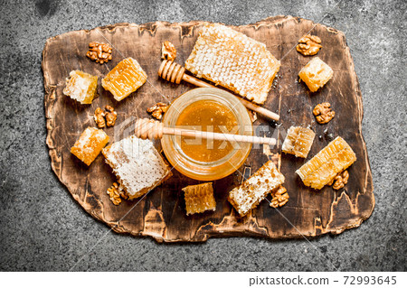 Fresh honey in a jar and honeycomb with nuts. Fresh honey in a jar and honeycomb with nuts. 72993645