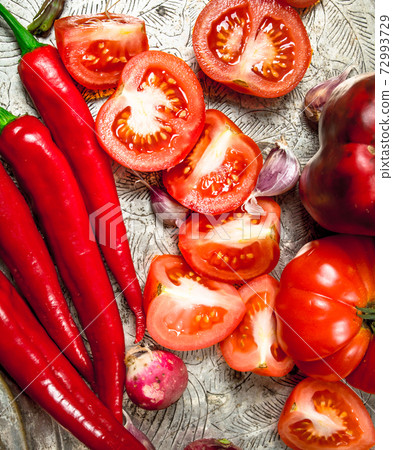 Red organic food. Fresh hot chili pepper, tomatoes and sweet pepper on a steel tray. 72993729