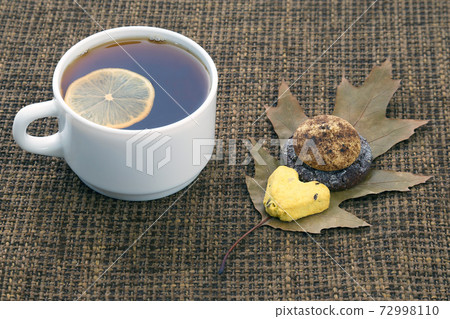 white cup of tea with lemon and biscuits white cup of tea with lemon and biscuits 72998110