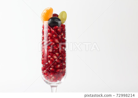 pomegranate seeds in the glass on a light background pomegranate seeds in the glass on a light background 72998214