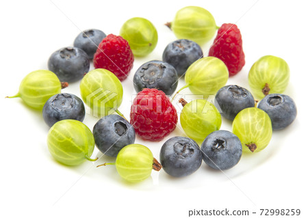 Assorted fresh different berries on a white plate. Assorted fresh different berries on a white plate. 72998259