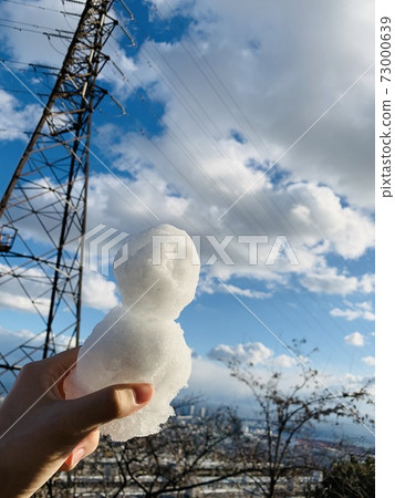 Winter blue sky and snowman 73000639