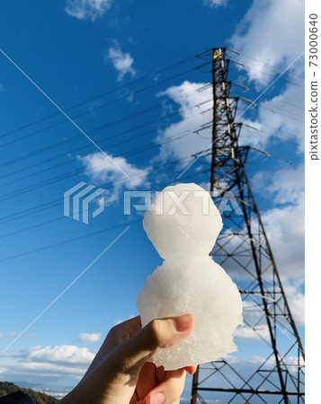 Winter blue sky and snowman 73000640