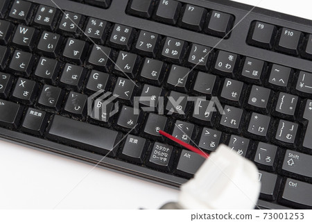 Cleaning the keyboard with an air duster 73001253