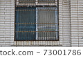 Windows covered with old iron bars 73001786