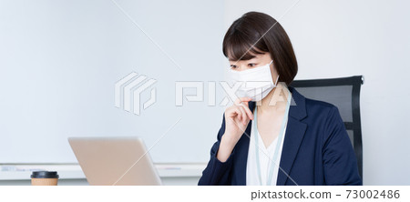 Banner size of a woman who works with a mask in the office Banner size of a woman who works with a mask in the office 73002486