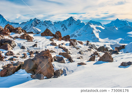Snowy blue mountains in clouds 73006176