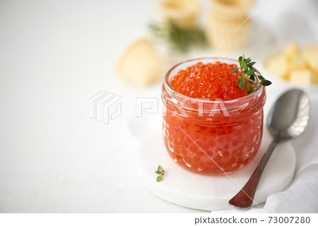 red salmon caviar in a glass jar 73007280