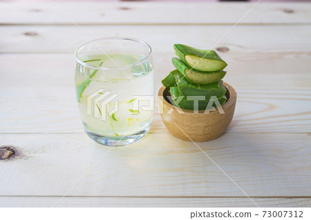 Aloe Vera for drinking on wood table 73007312