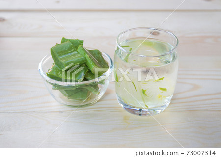 Aloe Vera for drinking on wood table 73007314