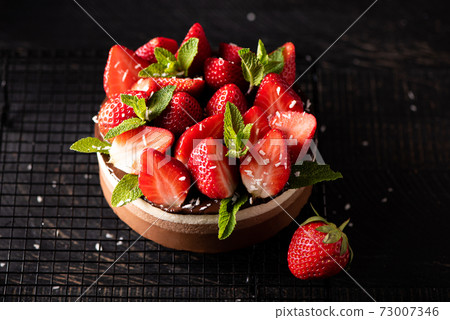 round chocolate cake with fresh strawberries and mint round chocolate cake with fresh strawberries and mint 73007346