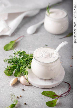 fresh greek yogurt with herbs and spices in glass jars fresh greek yogurt with herbs and spices in glass jars 73007366