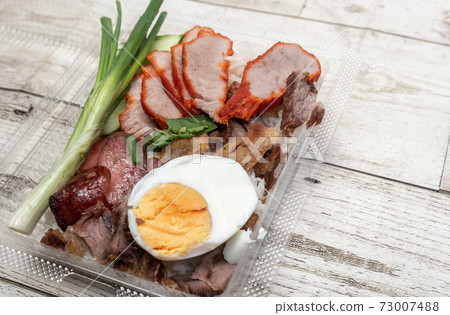 crispy pork belly on topped rice - Asian food style.Asian street food on wooden floor, Thai food 73007488