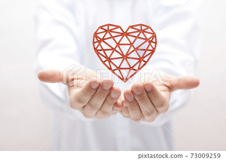 Red openwork heart in hands Red openwork heart in hands 73009259