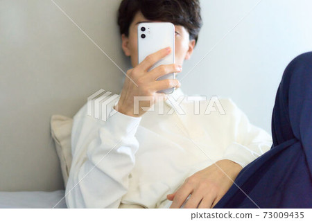Hands of a man touching a smartphone Hands of a man touching a smartphone 73009435