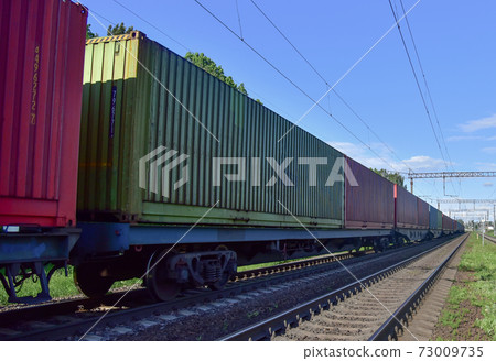 Cargo Containers Transportation On Freight Train By Railway. Intermodal Container On Train Car. Cargo Containers Transportation On Freight Train By Railway. Intermodal Container On Train Car. 73009735
