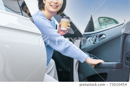 A young woman driving A young woman driving 73010454