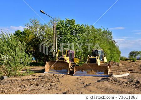 Track-type bulldozers during of large construction jobs at building site. Track-type bulldozers during of large construction jobs at building site. 73011868