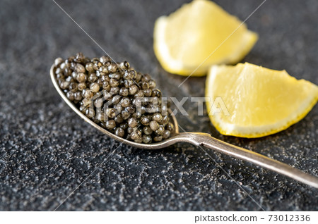 Spoon of black caviar Spoon of black caviar 73012336