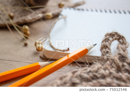 Natural jute rolls for making natural body jute washclothes, or for dishes, on light grey background with blank page with copyspace. Handmade DIY and hobby concept, selective focus 73012546