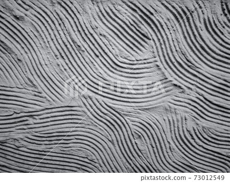 Decorative plastered wall as creative abstract background in ultimate gray color with copy space - color of the year 2021 concept. Selective focus Decorative plastered wall as creative abstract background in ultimate gray color with copy space - color of the year 2021 concept. Selective focus 73012549