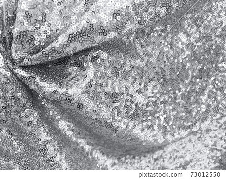 Festive sequins fabric background in gray color - abstract backdrop for Holiday and party banner demonstrating color of the year 2021. Glamour shiny background with sequin texture, selective focus 73012550