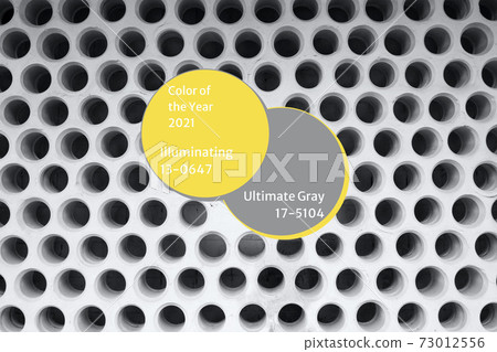 Brutal cement wall with a lot of small holes in ultimate gray and illuminating yellow colors - composition for color of the year 2021 concept. Selective focus. Urban background Brutal cement wall with a lot of small holes in ultimate gray and illuminating yellow colors - composition for color of the year 2021 concept. Selective focus. Urban background 73012556