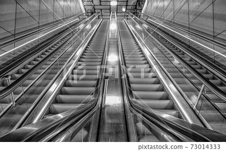 Upward view of a Silver Escalator with leading lines 73014333