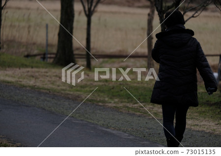 A woman walking A woman walking 73015135