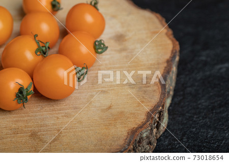 Close up photos of raw cherry tomatoes on wood board 73018654