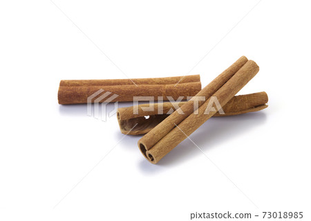 A heap of cinnamon sticks on white background A heap of cinnamon sticks on white background 73018985