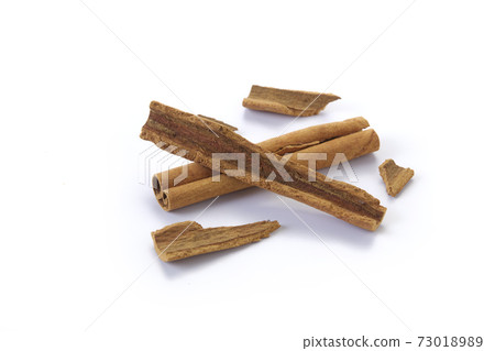 A heap of cinnamon sticks on white background A heap of cinnamon sticks on white background 73018989