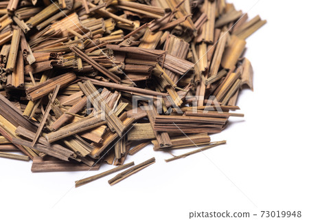 Organic dried lemongrass heap on white background Organic dried lemongrass heap on white background 73019948
