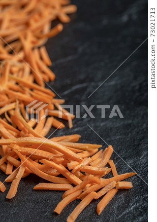 Close up Julienne of fresh organic carrot over black background Close up Julienne of fresh organic carrot over black background 73021713