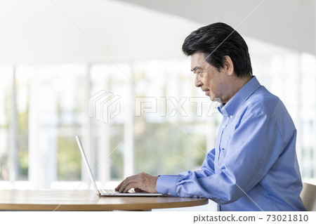 Senior man working on a computer Senior man working on a computer 73021810