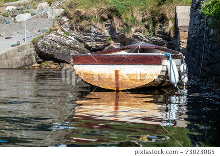 Rowing boat at the pier in Bruckless in County Donegal - Ireland. Rowing boat at the pier in Bruckless in County Donegal - Ireland. 73023085