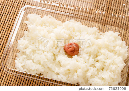 Rice (with pickled plums, Hinomaru bento) in a take-out container. 73023906