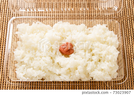Rice (with pickled plums, Hinomaru bento) in a take-out container. 73023907