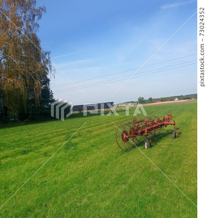 solar panels in green rural village yard solar panels in green rural village yard 73024352