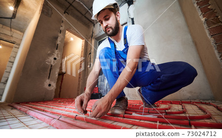Underfloor heating installation. Warm floor heating system Underfloor heating installation. Warm floor heating system 73024712