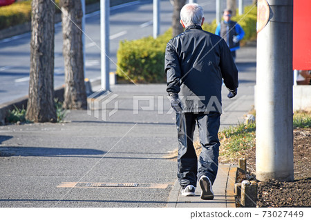 Senior walking cheerfully Senior walking cheerfully 73027449
