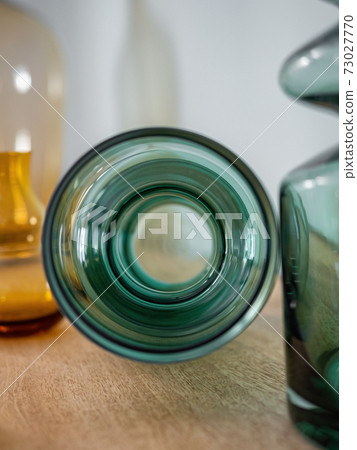 Close-up of decorative vase from transparent glass with view to inside. Close-up of decorative vase from transparent glass with view to inside. 73027770
