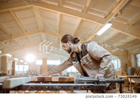 Carpenter working at the carpentry manufacturing 73028149