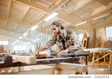 Carpenter working at the carpentry manufacturing Carpenter working at the carpentry manufacturing 73028153