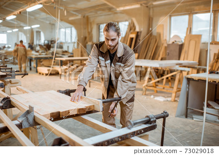 Carpenter working at the carpentry manufacturing 73029018